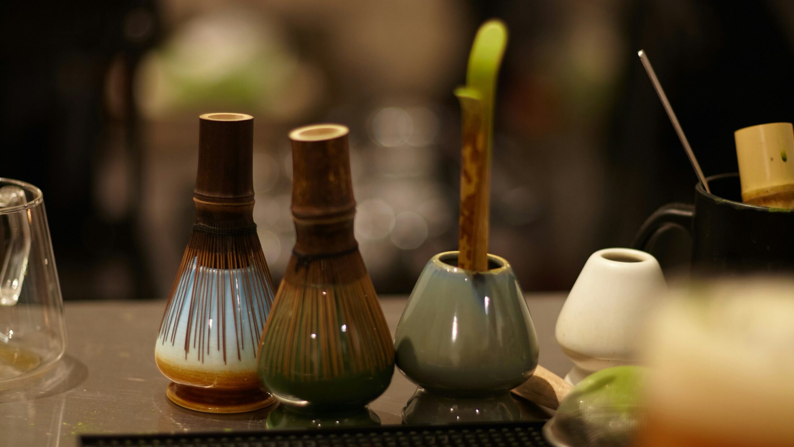 chasen bamboo matcha whisk resting on ceramic kusenaoshi holder